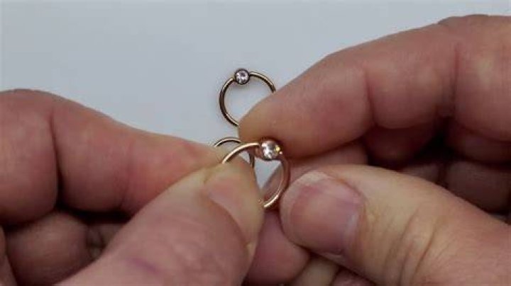 How do you take out a ball ring piercing?